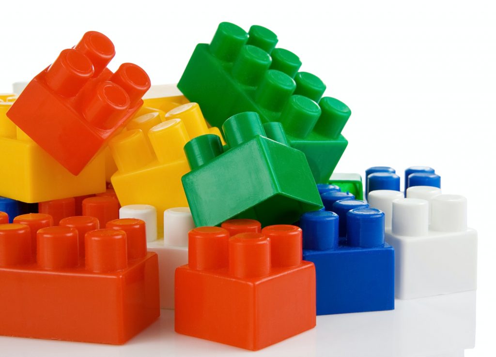 colorful plastic toys bricks isolated on white